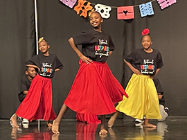  three students dancing in costume